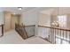 This hallway offers hardwood railing, neutral carpet, a chandelier, and neutral paint at 2748 Hidden Falls Dr, Buford, GA 30519