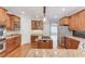 Spacious kitchen with wood cabinets, stainless steel appliances, and island cooktop at 2748 Hidden Falls Dr, Buford, GA 30519