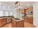 Modern kitchen with stainless steel appliances, wood cabinets, and granite countertops at 2748 Hidden Falls Dr, Buford, GA 30519