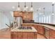 Open kitchen with stainless steel appliances, wooden cabinets and island cooktop at 2748 Hidden Falls Dr, Buford, GA 30519