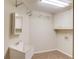 Convenient laundry room equipped with cabinets, shelves, and sink at 2748 Hidden Falls Dr, Buford, GA 30519