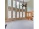 Bright living room with soaring ceilings, a ceiling fan, and large windows at 2748 Hidden Falls Dr, Buford, GA 30519