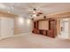 Entertainment area with carpet, built in shelves, ceiling fan and recessed lighting at 2748 Hidden Falls Dr, Buford, GA 30519