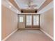 Bright living room with ceiling fan, speakers, and trim, flooded with natural light from shuttered windows at 2748 Hidden Falls Dr, Buford, GA 30519