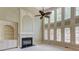 Elegant living room featuring a fireplace, built-in shelving, and large windows at 2748 Hidden Falls Dr, Buford, GA 30519