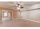 Large open living room with neutral walls and carpet, and ceiling fan with lighting at 2748 Hidden Falls Dr, Buford, GA 30519