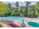 Community pool featuring ample lounge seating and mature trees at 2748 Hidden Falls Dr, Buford, GA 30519