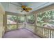 Relaxing screened porch with ceiling fan and wooded backyard views at 2748 Hidden Falls Dr, Buford, GA 30519