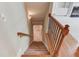 Carpeted staircase with wooden railing leading to hardwood floors at 2748 Hidden Falls Dr, Buford, GA 30519