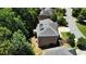 Aerial view showing a home's roof and the backyard with a tree lined street at 5059 Belair Bluff Se Ct, Smyrna, GA 30126