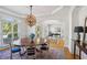 Formal dining area with large windows, chandelier, and hardwood floors, perfect for gatherings at 5059 Belair Bluff Se Ct, Smyrna, GA 30126