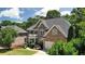 Brick two-story home with a manicured lawn and mature landscaping offers curb appeal at 5059 Belair Bluff Se Ct, Smyrna, GA 30126
