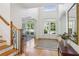 Bright foyer features hardwood floors, a staircase, and a view into the dining area at 5059 Belair Bluff Se Ct, Smyrna, GA 30126