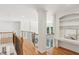 Bright hallway with hardwood floors, decorative iron railing, and custom built-ins at 5059 Belair Bluff Se Ct, Smyrna, GA 30126