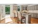Bright eat-in kitchen boasts granite countertops, stainless appliances, and adjacent access to outdoor patio at 5059 Belair Bluff Se Ct, Smyrna, GA 30126