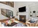 Cozy living room features a fireplace, built-in shelving, and plenty of natural light at 5059 Belair Bluff Se Ct, Smyrna, GA 30126