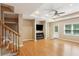 Open living area with hardwood floors, recessed lighting, ceiling fan, and a TV at 5059 Belair Bluff Se Ct, Smyrna, GA 30126