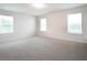 Large bedroom with neutral carpet, three windows, and neutral paint in a spacious layout at 904 Sundown Pt, Villa Rica, GA 30180