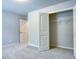 Bright bedroom with neutral carpet and paint, walk-in closet, and white doors at 904 Sundown Pt, Villa Rica, GA 30180