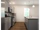 Modern kitchen featuring gray cabinets, stainless steel appliances, and granite countertops at 904 Sundown Pt, Villa Rica, GA 30180