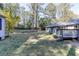 This home features a large grassy backyard area with mature trees at 1373 W Prospect Dr, Lawrenceville, GA 30043