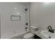 Bathroom with a soaking tub features white subway tile and black fixtures at 1373 W Prospect Dr, Lawrenceville, GA 30043