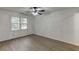 Large bedroom with hardwood floors features a ceiling fan, natural light, and neutral paint at 1373 W Prospect Dr, Lawrenceville, GA 30043