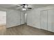 Spacious bedroom featuring ample closet space, hardwood floors, and a ceiling fan at 1373 W Prospect Dr, Lawrenceville, GA 30043