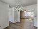 Open-concept dining room and living room feature light wood floors, white walls, with abundant light from many windows at 1373 W Prospect Dr, Lawrenceville, GA 30043