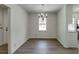 Bright dining room with stylish chandelier, light wood floors, white walls, and abundant natural light through the window at 1373 W Prospect Dr, Lawrenceville, GA 30043