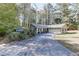 Lovely ranch-style home with an attached two-car garage, surrounded by beautiful trees and a long private drive at 1373 W Prospect Dr, Lawrenceville, GA 30043