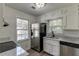 Well-lit kitchen with granite counters, stainless steel appliances, and new wood flooring at 1373 W Prospect Dr, Lawrenceville, GA 30043