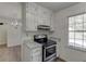 Cozy kitchen featuring granite countertops, stainless steel oven, and bright window at 1373 W Prospect Dr, Lawrenceville, GA 30043