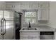 Bright kitchen featuring granite countertops, stainless steel appliances, and a window view at 1373 W Prospect Dr, Lawrenceville, GA 30043