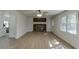 Bright living room with a brick fireplace, ceiling fan, hardwood flooring and large windows at 1373 W Prospect Dr, Lawrenceville, GA 30043