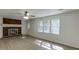 Bright living room features a brick fireplace, ceiling fan, hardwood flooring and large windows at 1373 W Prospect Dr, Lawrenceville, GA 30043