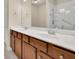 Bathroom features a double sink vanity with granite countertops and a tub with shower at 1550 Rolling View Dr, Cumming, GA 30040