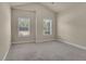 Carpeted bedroom features vaulted ceiling and two windows at 1550 Rolling View Dr, Cumming, GA 30040