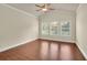Inviting bedroom featuring hardwood floors, white trim, and a modern ceiling fan at 1550 Rolling View Dr, Cumming, GA 30040