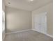 Carpeted bedroom featuring double doors and a window at 1550 Rolling View Dr, Cumming, GA 30040
