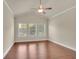 Bedroom features a vaulted ceiling and three windows at 1550 Rolling View Dr, Cumming, GA 30040