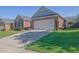 Charming brick home with well-maintained lawn, mature landscaping, and two car garage at 1550 Rolling View Dr, Cumming, GA 30040