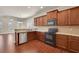 Updated kitchen with granite countertops, stainless steel appliances, and hardwood floors at 1550 Rolling View Dr, Cumming, GA 30040