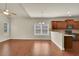 Open kitchen/dining area with hardwood floors and stainless steel appliances at 1550 Rolling View Dr, Cumming, GA 30040