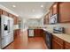 Updated kitchen featuring stainless appliances, granite counters, and rich, wood cabinets at 1550 Rolling View Dr, Cumming, GA 30040