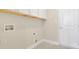 Clean laundry room featuring white cabinets, hookups, and tile floor at 1550 Rolling View Dr, Cumming, GA 30040
