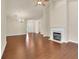 Open-concept living area with hardwood floors, a fireplace, and plenty of natural light, perfect for Gathering gatherings at 1550 Rolling View Dr, Cumming, GA 30040