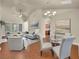 Spacious living room featuring hardwood floors, a vaulted ceiling, and ample natural light from large windows at 1550 Rolling View Dr, Cumming, GA 30040