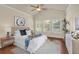 Cozy bedroom with a queen-sized bed, natural light, and ample storage with hardwood floors and a ceiling fan at 1550 Rolling View Dr, Cumming, GA 30040