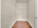 Walk-in closet has laminate flooring and white shelving at 1550 Rolling View Dr, Cumming, GA 30040